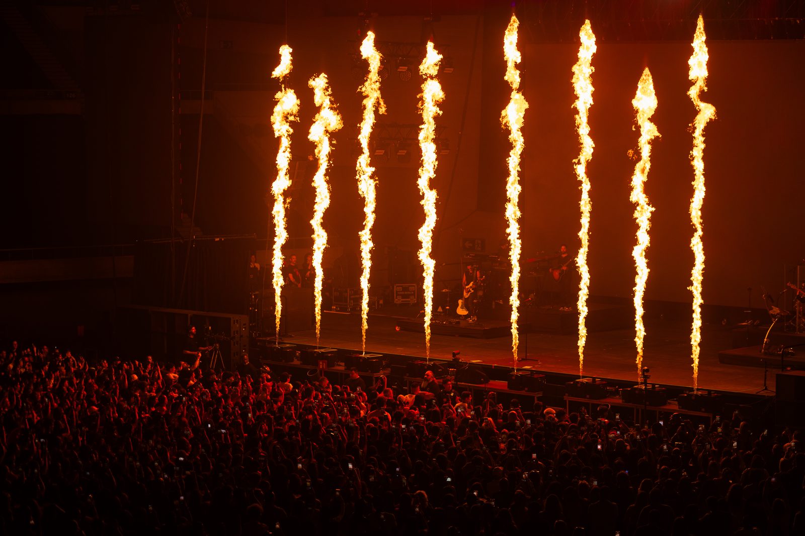 Fire columns over the stage at a sold-out arena show