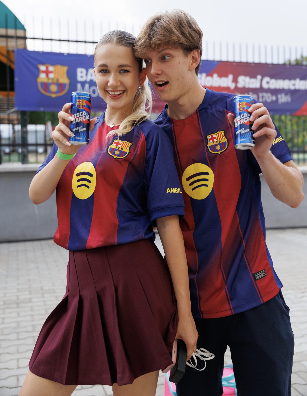 Fans in FC Barcelona kits with cans
